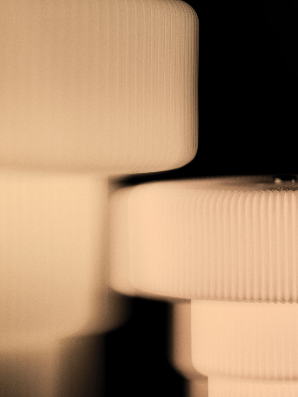 Close-up of the lit shade, showing the rippled surface and stepped silhouette