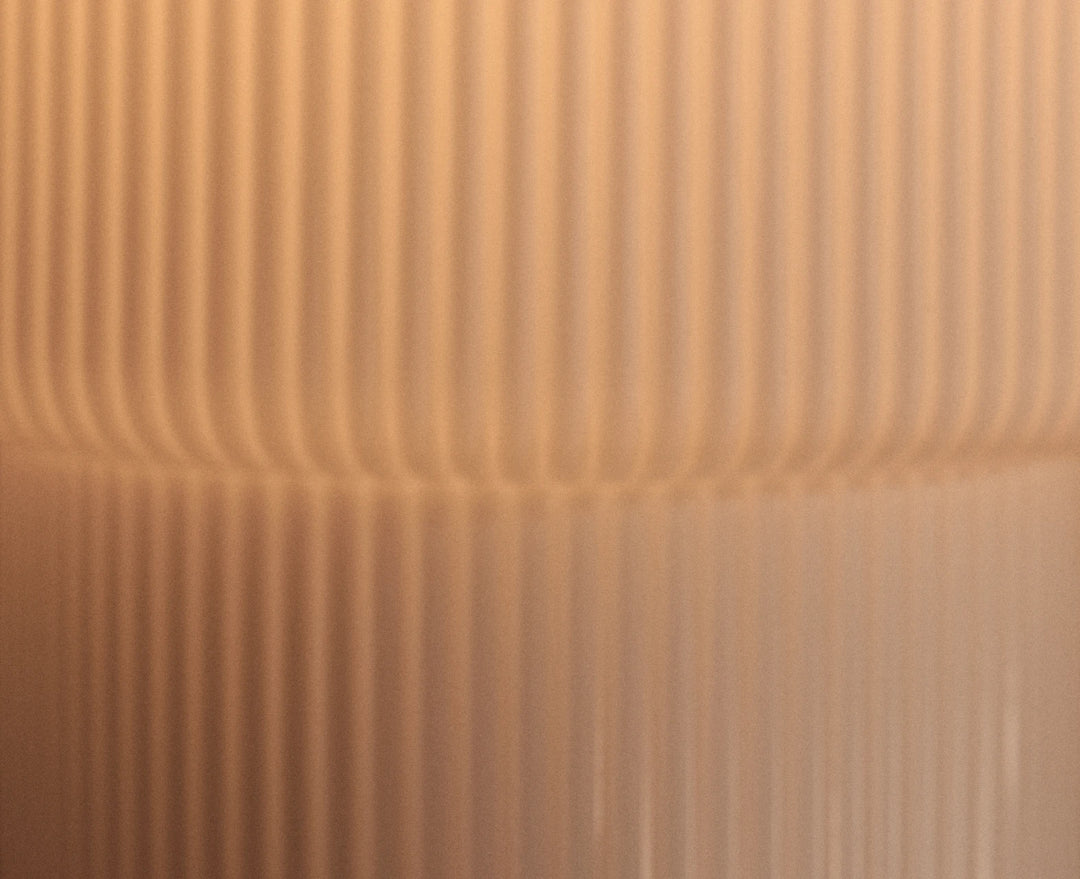 Sale lighting collection, lit fluted table lamp on a side table beside a glass, with close-up of its ribbed shade