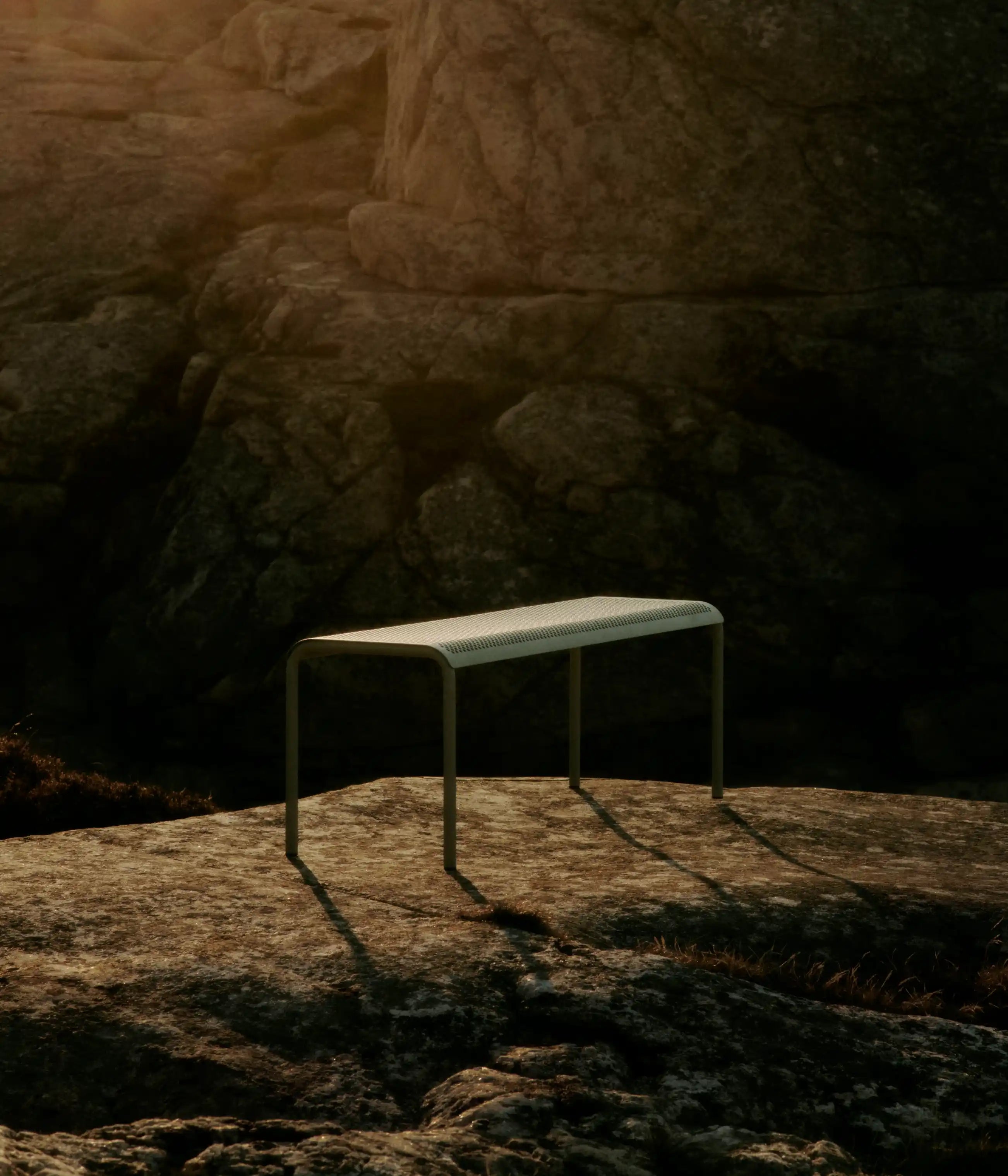 Outdoor Furniture collection, perforated bench on a sunlit rock face